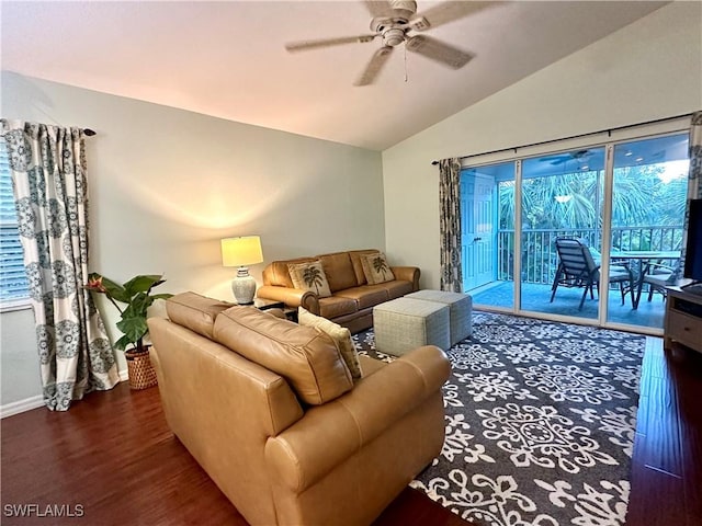 living room with a ceiling fan, lofted ceiling, dark wood-style flooring, and baseboards