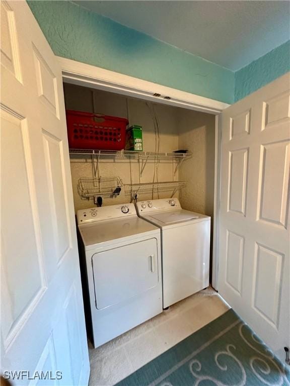 laundry area with laundry area and washer and clothes dryer