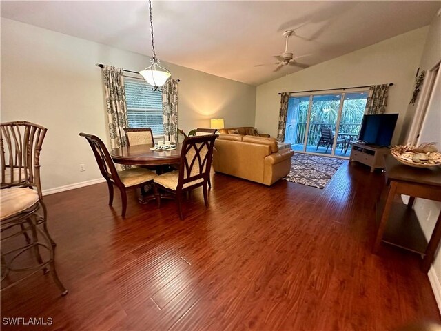 dining space featuring dark hardwood / wood-style flooring, vaulted ceiling, and ceiling fan