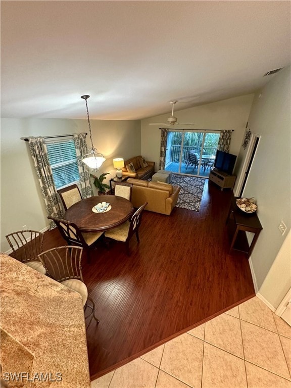 dining room featuring light tile patterned floors, vaulted ceiling, and ceiling fan