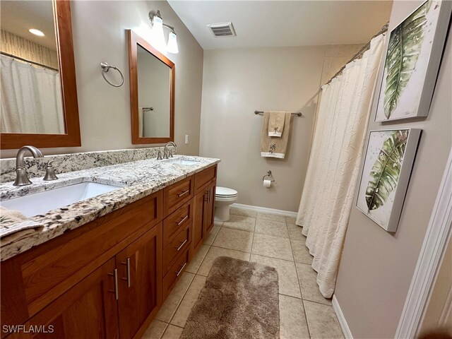 bathroom with tile patterned floors, vanity, and toilet