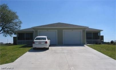 ranch-style house with a garage and a front lawn