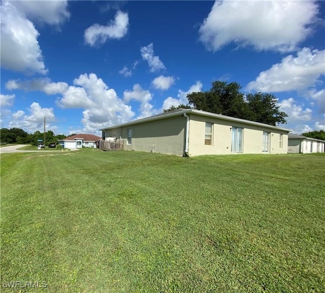 view of side of home featuring a lawn