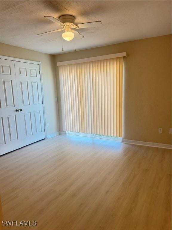 spare room featuring hardwood / wood-style floors and ceiling fan