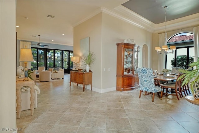 dining area featuring arched walkways, ornamental molding, plenty of natural light, and visible vents