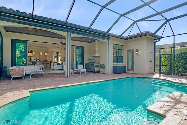 outdoor pool with a lanai, a patio area, an outdoor hangout area, and a ceiling fan