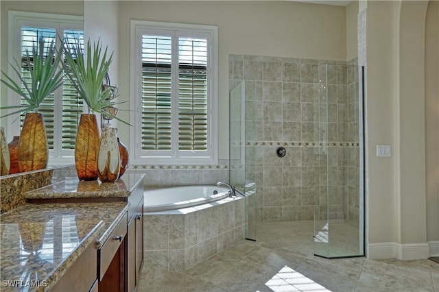 bathroom with vanity, a stall shower, tile patterned flooring, and a bath