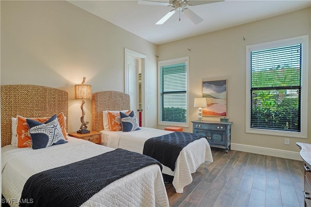 bedroom with dark wood-style floors, baseboards, and a ceiling fan