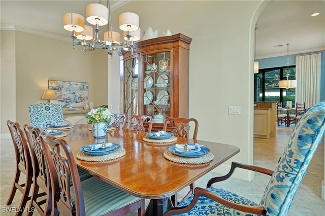 dining area featuring arched walkways, ornamental molding, light tile patterned floors, and a notable chandelier