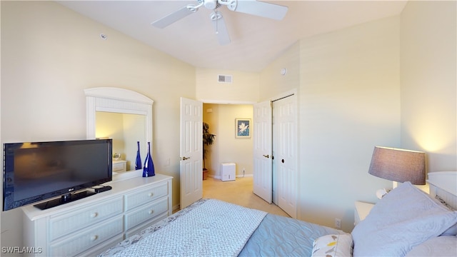 carpeted bedroom featuring ceiling fan and a closet