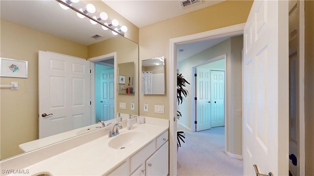 bathroom featuring vanity, visible vents, and baseboards