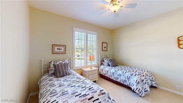 bedroom featuring light colored carpet and ceiling fan