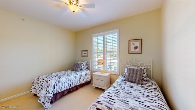 bedroom featuring baseboards, ceiling fan, and light colored carpet