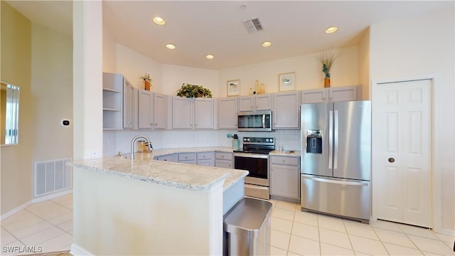 kitchen with open shelves, a peninsula, visible vents, and stainless steel appliances