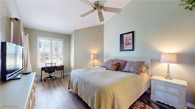 bedroom featuring ceiling fan, light hardwood / wood-style floors, and lofted ceiling