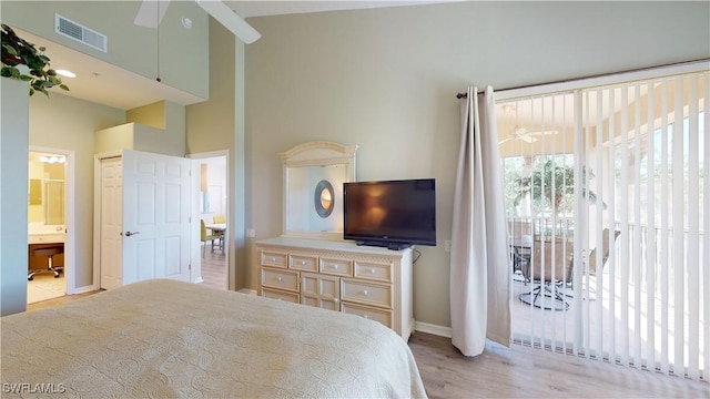 bedroom featuring ensuite bathroom, light wood-style flooring, visible vents, baseboards, and access to outside