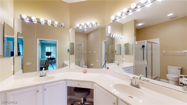 bathroom featuring an enclosed shower, toilet, vanity, and tile patterned floors