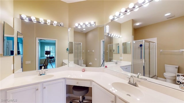 ensuite bathroom with a stall shower, visible vents, toilet, ensuite bathroom, and vanity