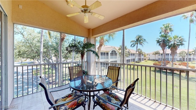 sunroom featuring ceiling fan and lofted ceiling