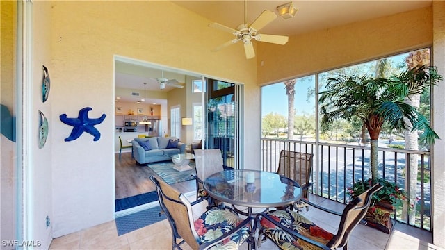 sunroom / solarium featuring ceiling fan