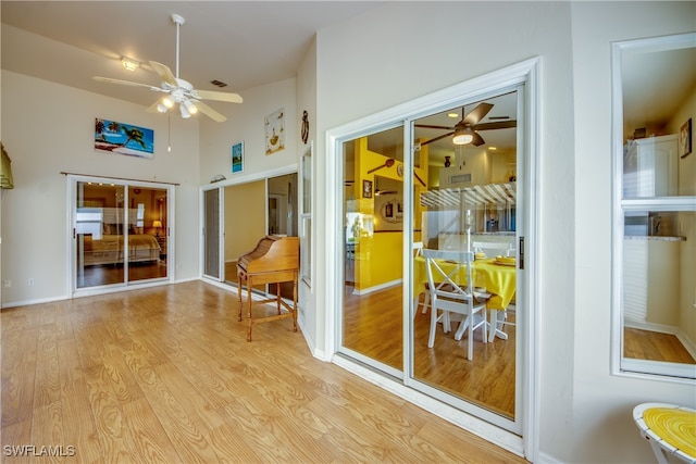 doorway to outside with ceiling fan and light hardwood / wood-style flooring