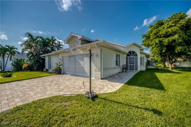 view of front of property with a garage and a front yard