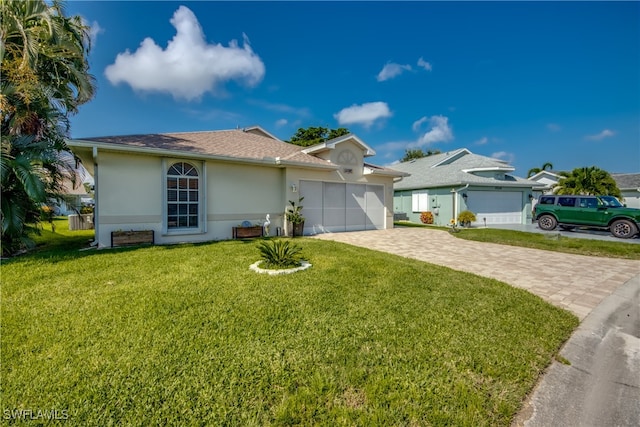 single story home featuring a garage and a front lawn