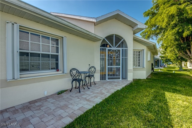 rear view of house featuring a patio area and a yard