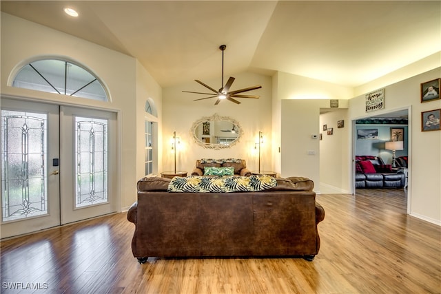 living room featuring ceiling fan, light hardwood / wood-style floors, french doors, and lofted ceiling