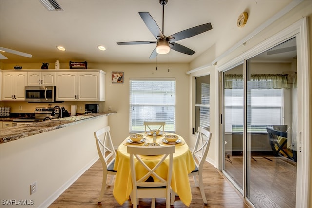 dining space featuring light hardwood / wood-style flooring and ceiling fan