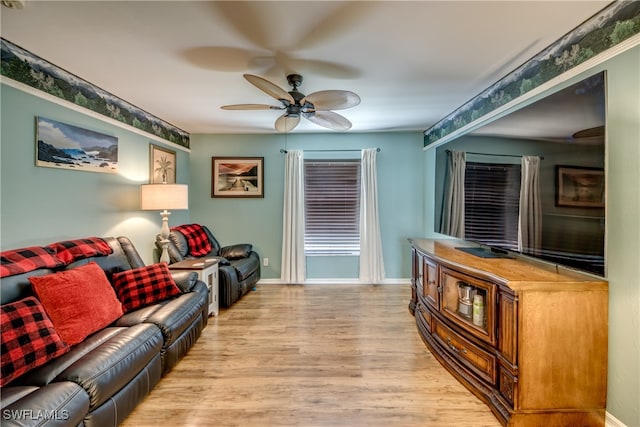 living room with ceiling fan and wood-type flooring