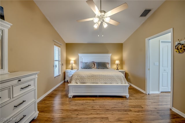 bedroom with ceiling fan, vaulted ceiling, and light hardwood / wood-style flooring