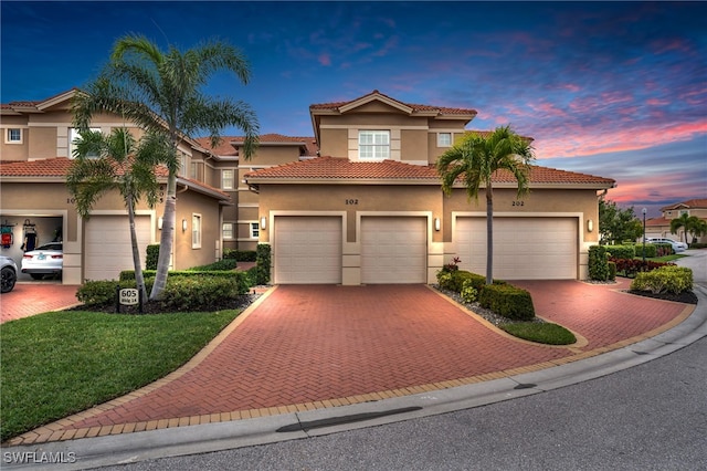 mediterranean / spanish home featuring a garage