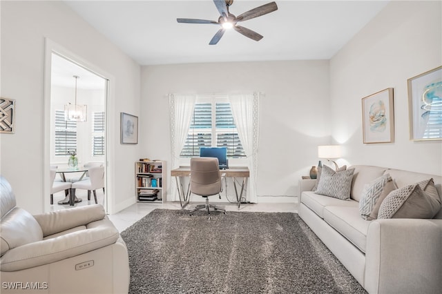 tiled living room with ceiling fan with notable chandelier and a healthy amount of sunlight