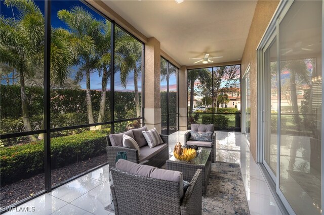 sunroom / solarium featuring ceiling fan