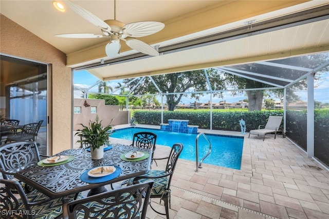 view of swimming pool featuring pool water feature, a lanai, and a patio area