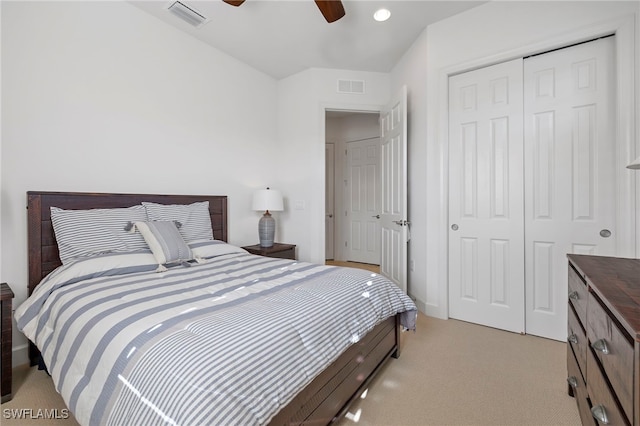 carpeted bedroom with ceiling fan and a closet