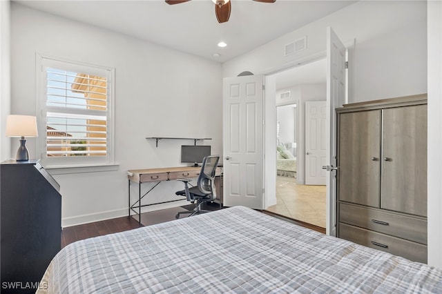 bedroom with ceiling fan and dark hardwood / wood-style floors