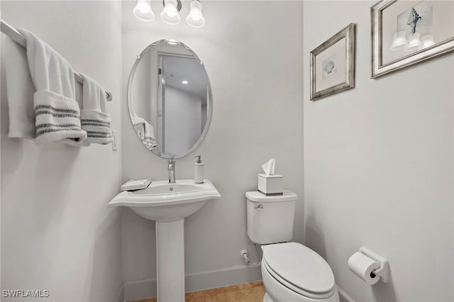 bathroom with tile patterned flooring and toilet