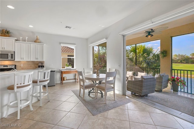 dining room with ceiling fan and light tile patterned floors