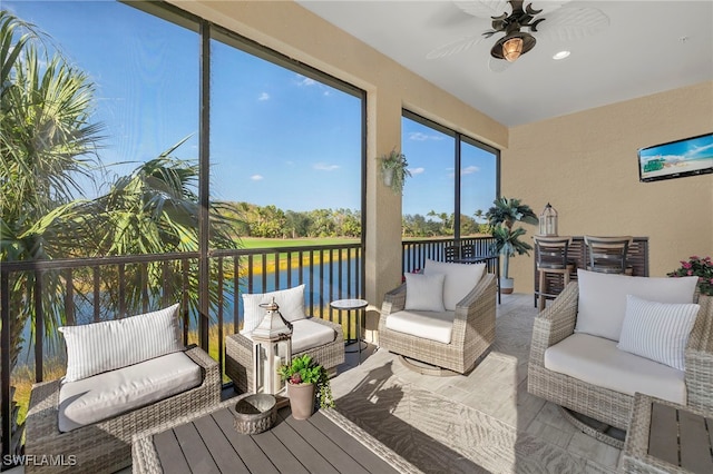 sunroom / solarium featuring ceiling fan