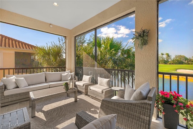 sunroom / solarium featuring a water view