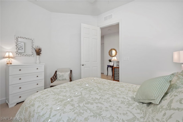 bedroom featuring light colored carpet