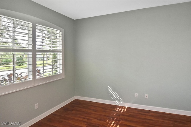 spare room with hardwood / wood-style floors and a healthy amount of sunlight