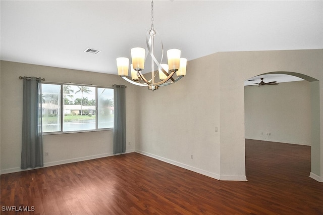 spare room featuring dark hardwood / wood-style floors, a notable chandelier, and lofted ceiling