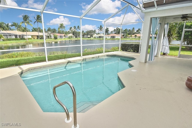 view of swimming pool featuring ceiling fan, glass enclosure, and a patio area