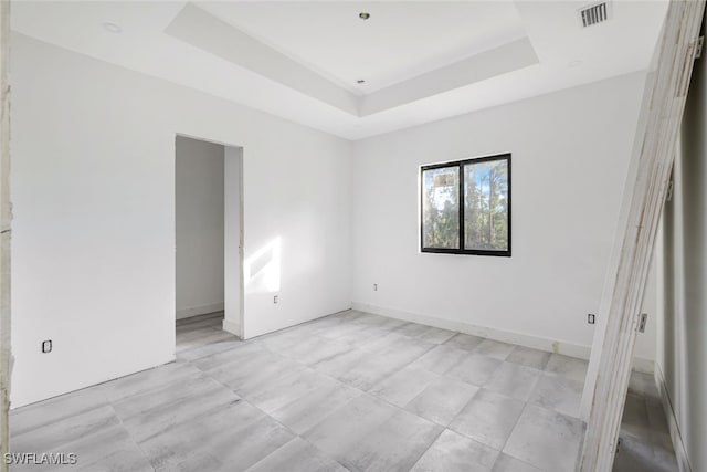 spare room featuring a tray ceiling