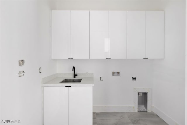 clothes washing area featuring hookup for a washing machine, sink, hookup for an electric dryer, and cabinets