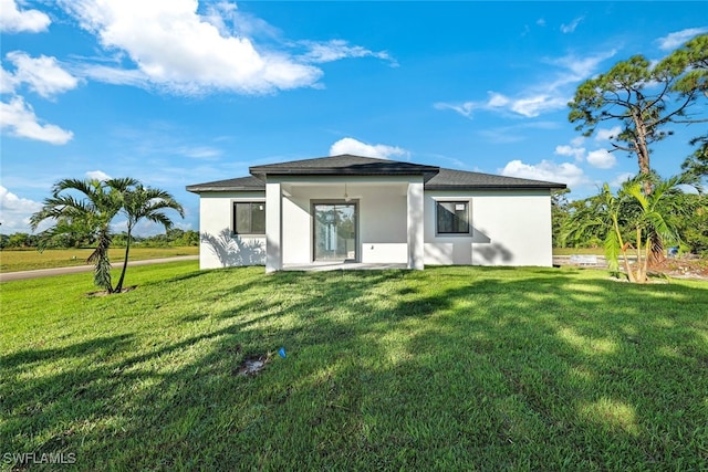 rear view of house with a lawn