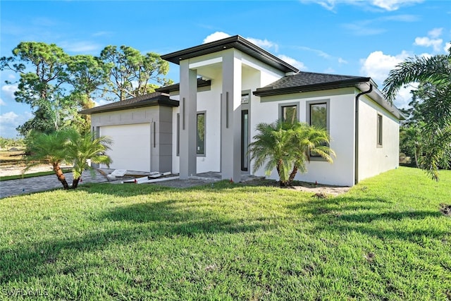 view of front facade with a front yard and a garage